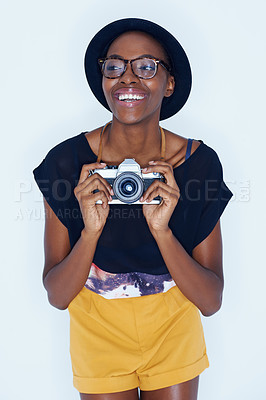 Buy stock photo Black woman, photographer and happiness in studio with camera, creativity and talent in media in artist career. Young person, positive and vision for photoshoot and focus lens by white background