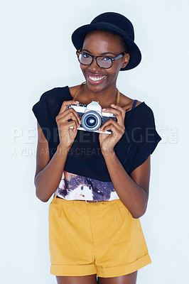 Buy stock photo Black woman, photographer and positive in studio with camera, creativity and media for artist with creative talent. Young person, happiness and face for photoshoot, lens and focus by white background