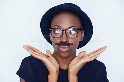 Buy stock photo Funny, woman and mustache on face in studio with hipster fashion and creative model in background or mockup. Silly, nerd and African person with goofy style and joke with trendy hat or unique outfit