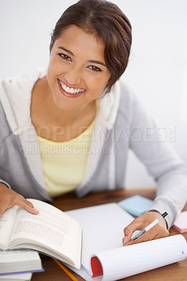 Buy stock photo Portrait, writing and happy student studying in college, learning and reading for project at desk. Face, books and woman at table for education, knowledge and info for notes in university in Brazil