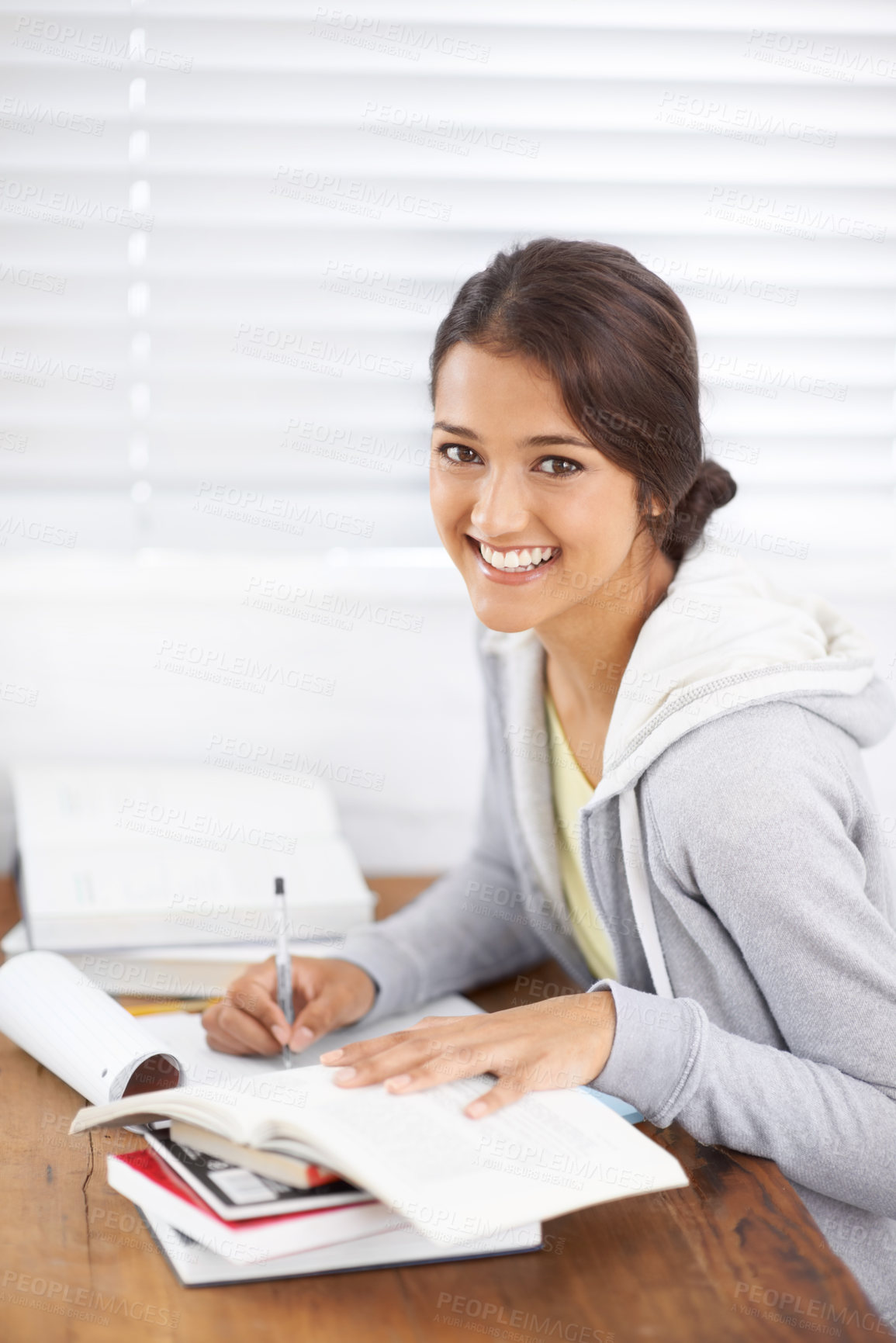 Buy stock photo Portrait, writing and happy woman studying in college, learning and reading for school project at desk. Face, books and student at table for education, knowledge and notes in university in Brazil