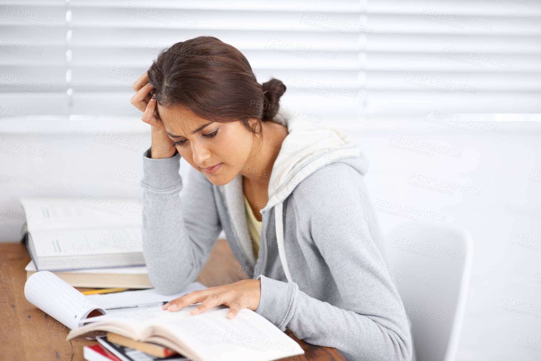 Buy stock photo Student, woman and confused with reading or books for study, knowledge and education with notes for learning.
Young person, girl and studying at desk with novel for scholarship, project or assessment