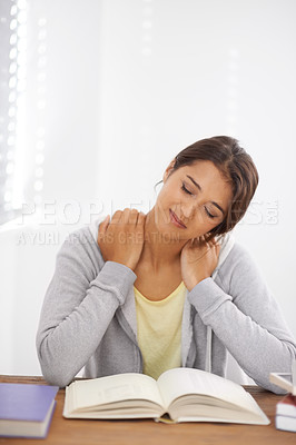 Buy stock photo Student, woman and neck pain with books for study, knowledge or education and burnout in bedroom.
Young person, girl and muscle ache or tired at desk with novel for scholarship, project or assessment