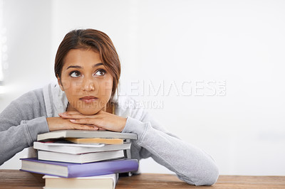 Buy stock photo Closeup shot of an attractive college student leaning on her books and looking thoughtful