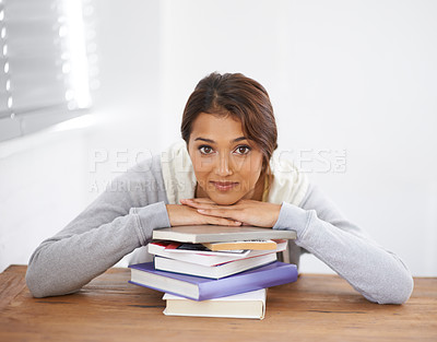 Buy stock photo Portrait, leaning on books and woman at desk in college, studying or reading for school project. Face, textbook stack and student at table for education, knowledge or learning at university in Brazil