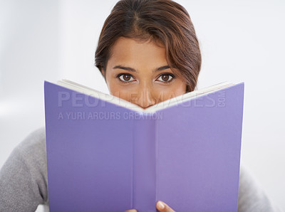 Buy stock photo Woman, student or portrait with book in studio, reading or closeup for research of assignment. Young person, indian or face in notebook for test, studies or positive for education by white background