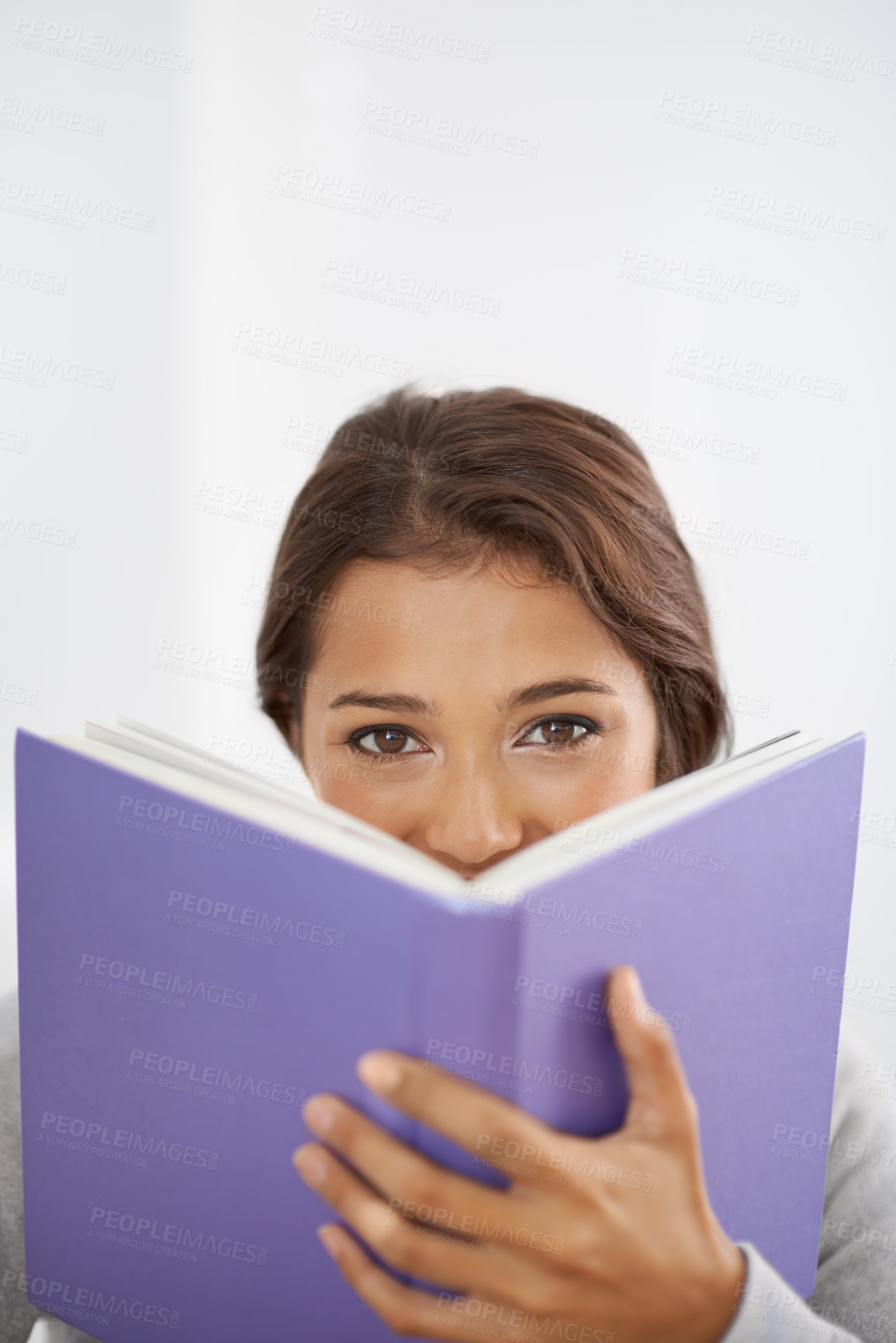 Buy stock photo Close up shot of a smiling, young woman reading her book