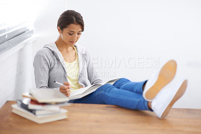 Buy stock photo Student, woman and reading or writing with books for study, knowledge or education with learning in bedroom.
Young person, girl and information at desk with novel for scholarship, test and assessment