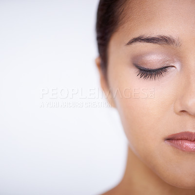 Buy stock photo Cropped studio shot of a beautiful young woman with her eyes closed
