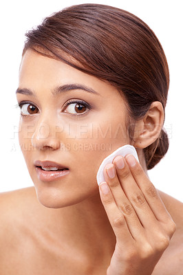 Buy stock photo Portrait of a beautiful young woman moisturizing her face