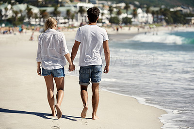 Buy stock photo Couple, walk and back on beach, holding hands or outdoor in summer sunshine for vacation, thinking or travel. Man, woman and care with love, bonding or holiday by ocean for adventure in Naples, Italy