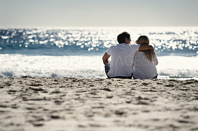 Buy stock photo Love, hugging and couple sitting on beach for date, outdoor bonding and tropical holiday. Romance, man and woman at sea, embrace and relax on ocean vacation together with travel, care and adventure.