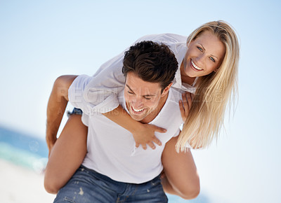 Buy stock photo Smile, piggy back and happy couple on beach for date, outdoor bonding and tropical holiday. Romance, man and woman in nature, love and relax on vacation together with travel, care and adventure hug.