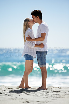 Buy stock photo Love, kiss and hug by couple at a beach with support, trust and security in nature together. Romance, care and people embrace at the ocean for bond, moment or travel, freedom or Bali summer vacation