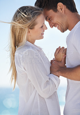 Buy stock photo Couple, beach and happy with love, support and care on a date by the sea with romance on vacation. Holiday, ocean and outdoor with summer travel in nature relax on a break and trip by the water