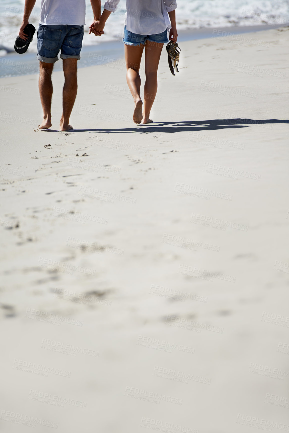 Buy stock photo Love, holding hands and legs of couple on beach for date, outdoor bonding and tropical holiday. Romance, man and woman from back, walk and relax on vacation together with travel, care and adventure.