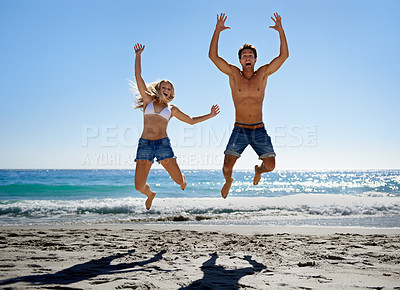 Buy stock photo Couple, jump and excited at beach, smile and portrait in summer sunshine for vacation, outdoor or travel. Man, woman and happy with love, bonding and holiday by ocean for adventure in Naples, Italy
