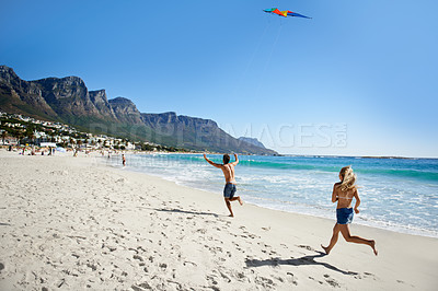 Buy stock photo Couple, running and summer with kite, beach and summer sunshine for vacation, freedom or play in air. Man, woman and speed to launch wind toys, bonding or holiday by sea on adventure in Naples, Italy