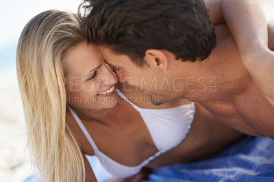 Buy stock photo Beach, couple smile and embrace with love, support and care on holiday by the sea and ocean. Romance, bonding and kiss with young people together on vacation adventure on sand about to kiss on a date