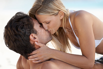 Buy stock photo Beach, couple kiss and embrace with love, support and care on holiday by the sea and ocean. Romance, bonding and kiss with young people together on vacation adventure on sand on a date with travel
