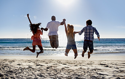 Buy stock photo Jump, beach and back of friends holding hands on holiday vacation together in summer at sea. Group, happy or excited men with women in fun celebration of freedom by ocean, sand, nature for travel
