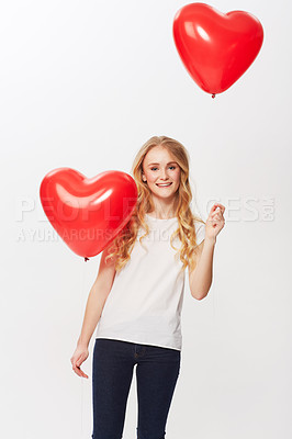 Buy stock photo Cropped view of a young woman holding a red heart in a studio