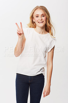 Buy stock photo Young woman, peace sign and portrait in studio for happiness, positive and funky in casual fashion. American model, smile and face with blond hair in trendy jeans, emoji and gen z by white background