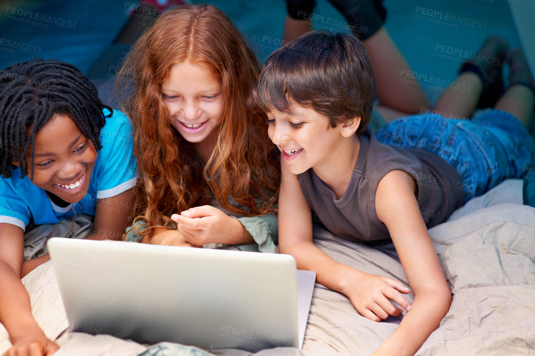 Buy stock photo Children enjoying using a laptop while out camping in a tent