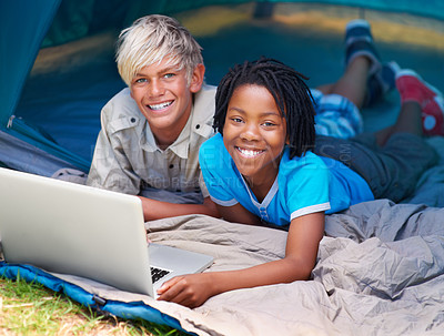 Buy stock photo Children, boys and happy with laptop for camping tent, social media and online movie with portrait in nature. Friends, face and kids with smile outdoor on grass for gaming, relax and holiday fun
