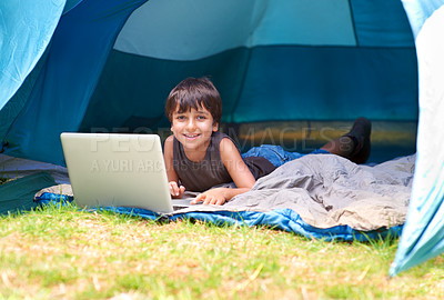 Buy stock photo Child, boy and happy with laptop in tent for camping, social media and online movie with portrait in nature. Person, face and kid with smile outdoor on grass for gaming, vacation relax or holiday fun