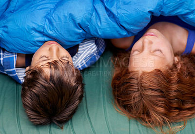 Buy stock photo Two young siblings sleeping inside their tent