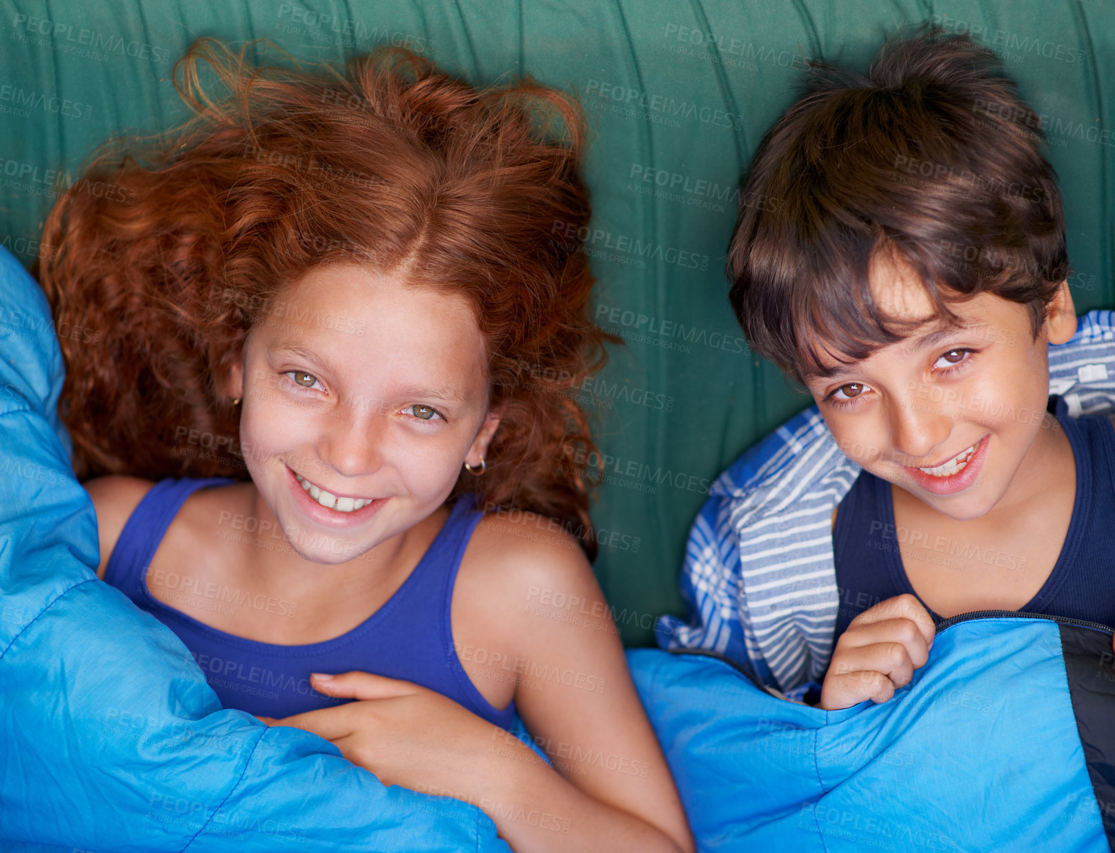 Buy stock photo Portrait of a young brother and sister lying down and smiling