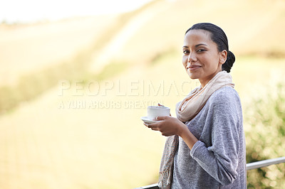 Buy stock photo Shot of a a young ethnic girl enjoying a cup of coffee outside