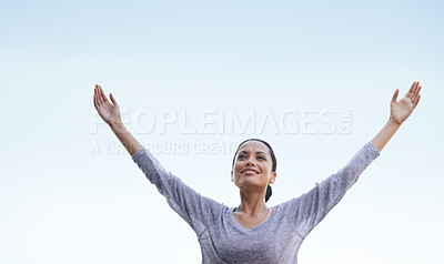 Buy stock photo A beautiful young woman standing outside with her arms outstretched