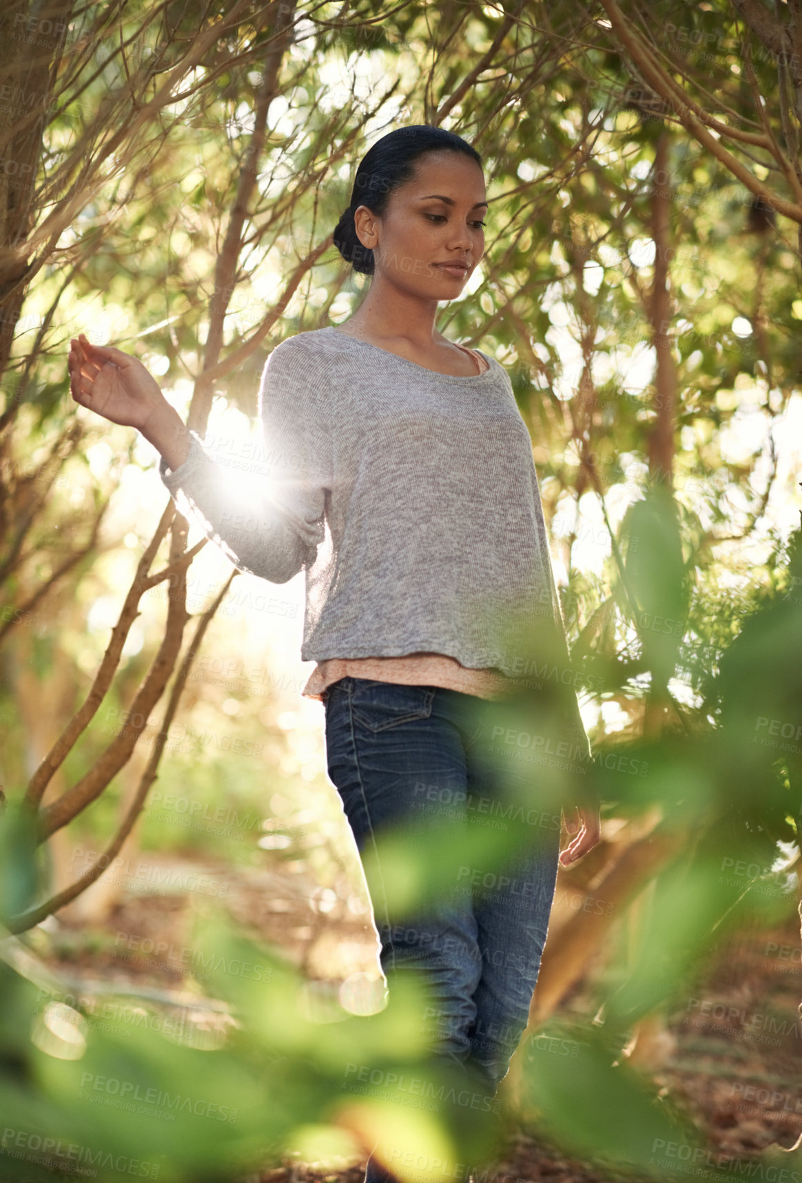 Buy stock photo A young woman enjoying a walk in the woods