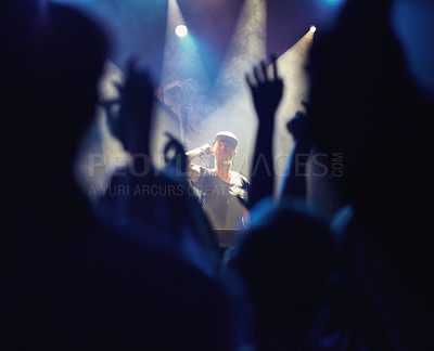 Buy stock photo Concert, DJ and music with hands from people at audience, band and festival event at a stage with lights. Rock show, dance and party with excited crowd with rave, techno and entertainment at night