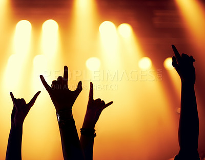 Buy stock photo Rock, concert and silhouette of hands with fans in celebration of music, festival and event at night with energy. People, party and emoji sign for metal or support at rave with light from stage