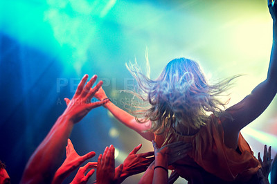 Buy stock photo A young girl crowd surfing as a band plays one of her favourite songs
