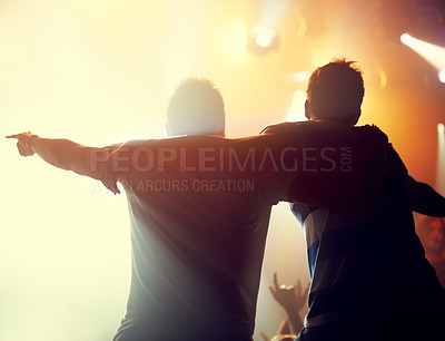 Buy stock photo Night, concert and friends dance to music at festival, event of party on holiday and vacation. Rock, fans and people embrace in celebration at club disco, rave and audience with light from stage