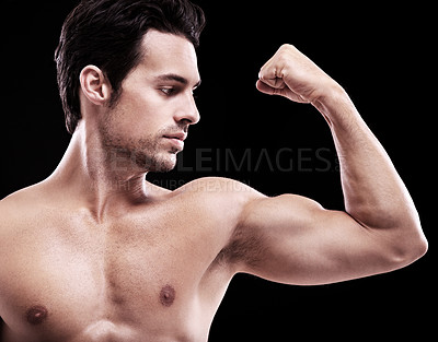 Buy stock photo Man, bodybuilder and bicep flex in studio, black background and exercise for muscular power. Strong, sexy and topless male model, sports athlete and arm muscle for pride, training and fitness results