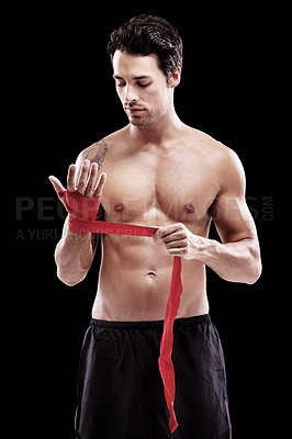 Buy stock photo Man, hand wrap and fitness with boxer in a studio ready for boxing training and workout. Body, athlete and male fighter from Brazil with exercise, sport and wellness for battle with black background