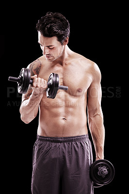 Buy stock photo Shot of a bare-chested young man lifting dumbbells isolated on black