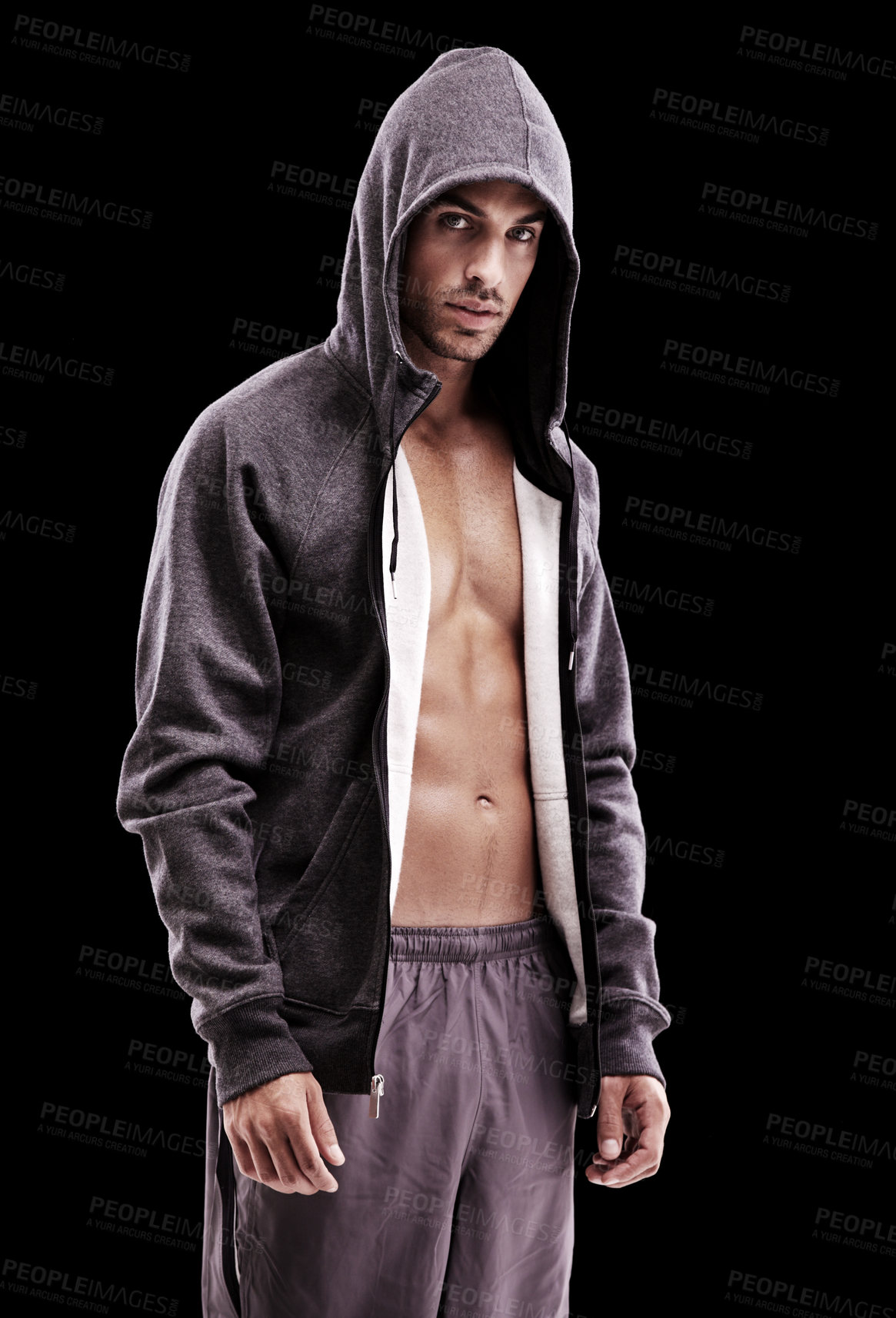 Buy stock photo Studio shot of a brooding bare-chested young man wearing a hoodie