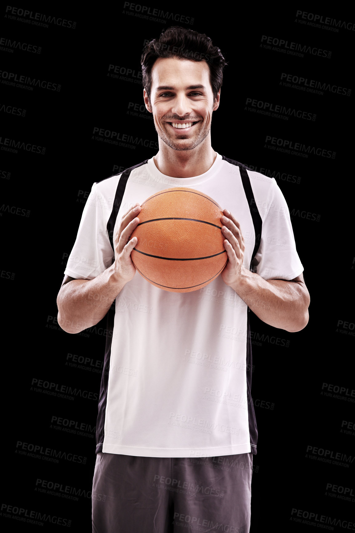 Buy stock photo Studio shot of a handsome young basketball player isolated on black