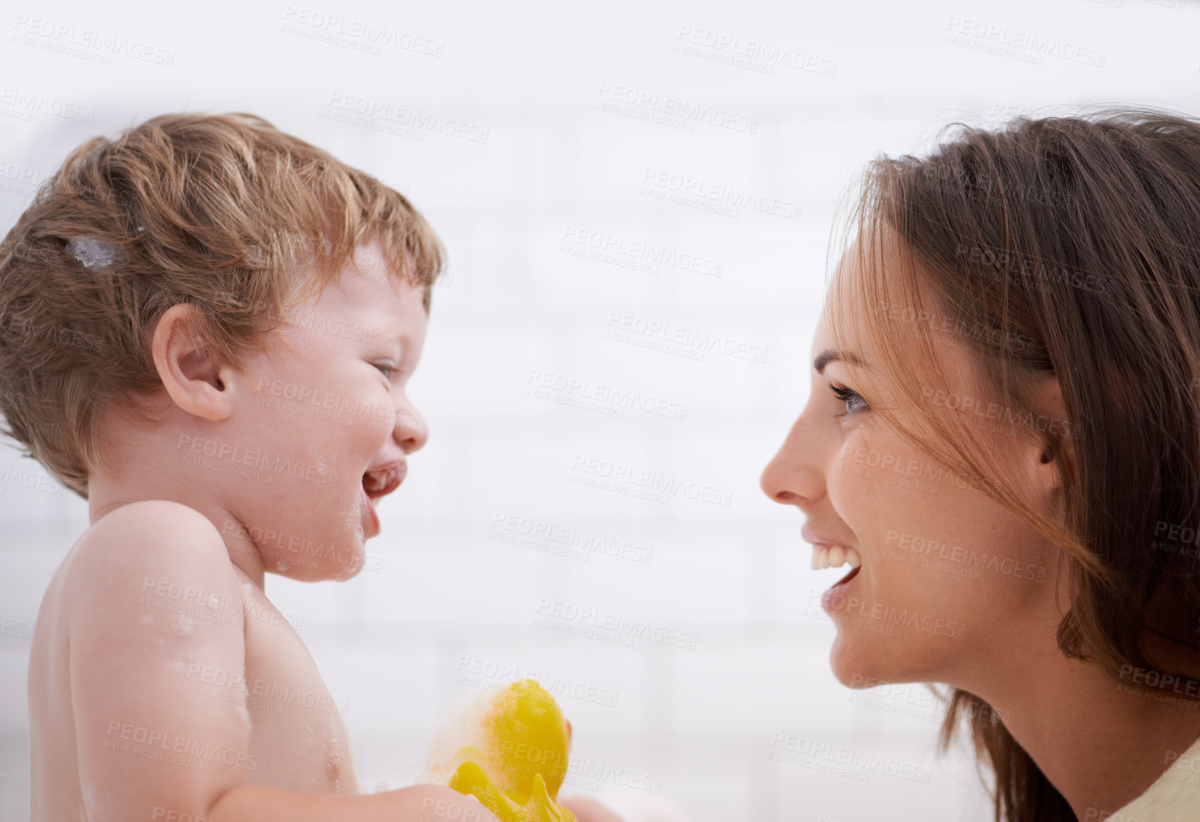 Buy stock photo Happy, rubber duck and mother bathing baby for hygiene, body care and health at family home. Smile, toy and young mom washing and bonding with infant, kid or child toddler in bathroom of house.