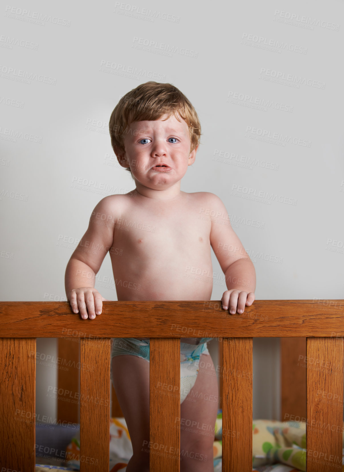 Buy stock photo Wailing toddler left alone in his crib