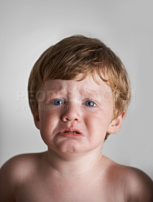 Buy stock photo Sad toddler, anxiety and portrait of baby in his home with emotional problem or loss in childhood. Crying, trouble and house with a frustrated young male kid, infant or boy with tears, fear or crisis