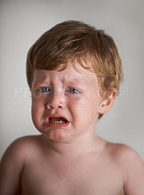 Buy stock photo Sad toddler, crying and portrait of boy in his home with emotional anger or loss in childhood. Moody, trouble and house with a frustrated young male kid, infant or baby with tears, fear or noise