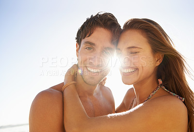 Buy stock photo Love, laugh and couple hug at a beach with comic, humor or bonding, comedy or silly joke in nature. Face, flare and funny people embrace at sea with goofy moment on summer, holiday or travel vacation