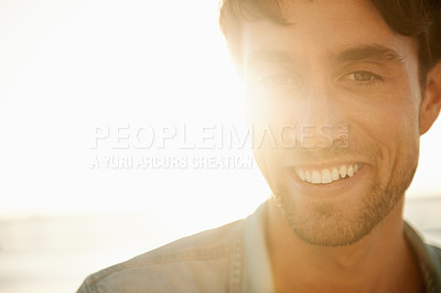 Buy stock photo Man, smile portrait and lens flare at the beach on a holiday and summer vacation outdoor with travel. Happy, sea and male person from California by the ocean with confidence and mockup with sunset